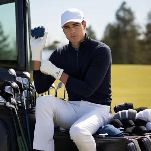 Golfer wearing glove sitting by golf clubs.