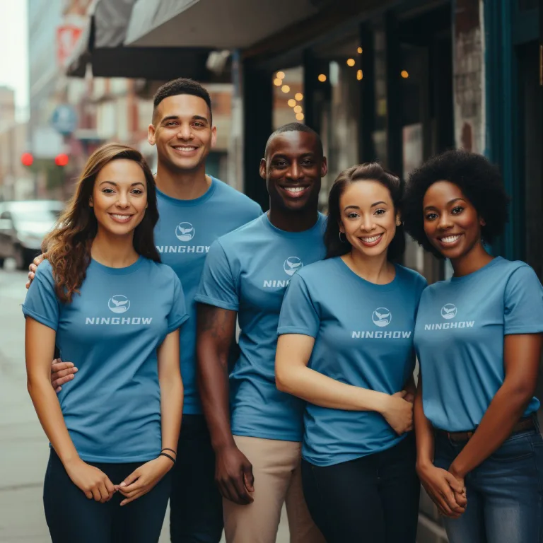 Group of smiling people wearing branded blue t-shirts.