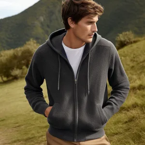 Man in gray hoodie outdoors, casual fashion.