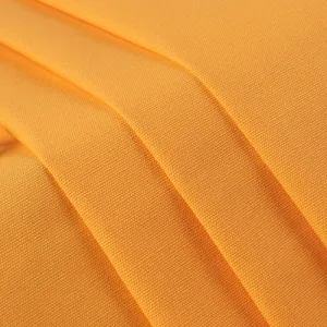cotton canvas Close-up of textured golden yellow fabric.
