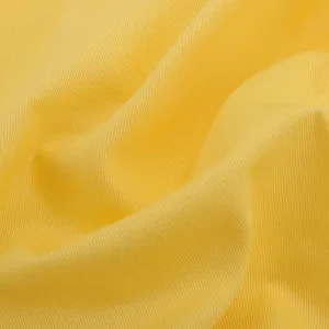 cotton chinos Close-up of yellow textured fabric.