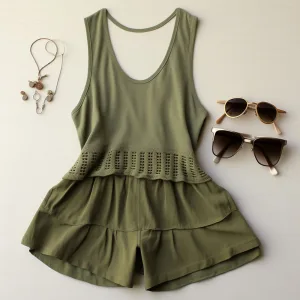 Green sleeveless top, skirt, sunglasses, and necklace.