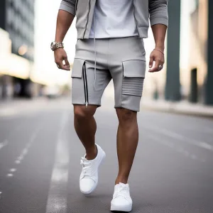 Man in stylish grey shorts and white sneakers on street.