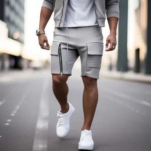 grey biker shorts d Man in stylish grey shorts and white sneakers on street.