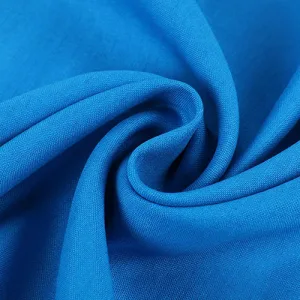 linen blends Close-up of textured blue fabric swirl.