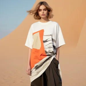 Woman in abstract print shirt desert backdrop.