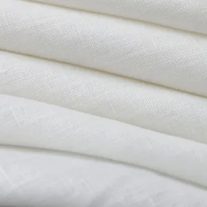 pure linen Close-up of white textured fabric folds.