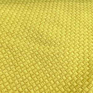 Yellow textured knit fabric close-up.