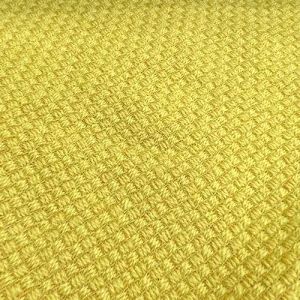 wool tweed Yellow textured knit fabric close-up.