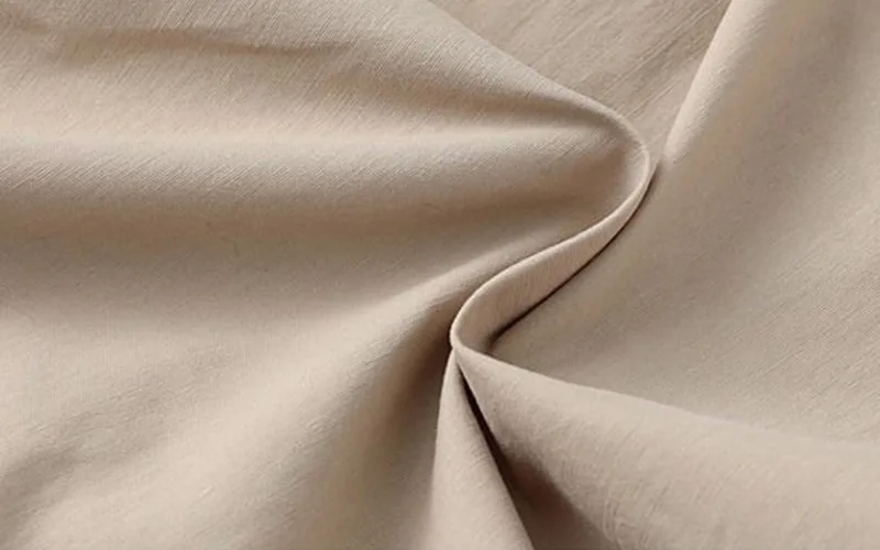 Beige fabric texture close-up.
