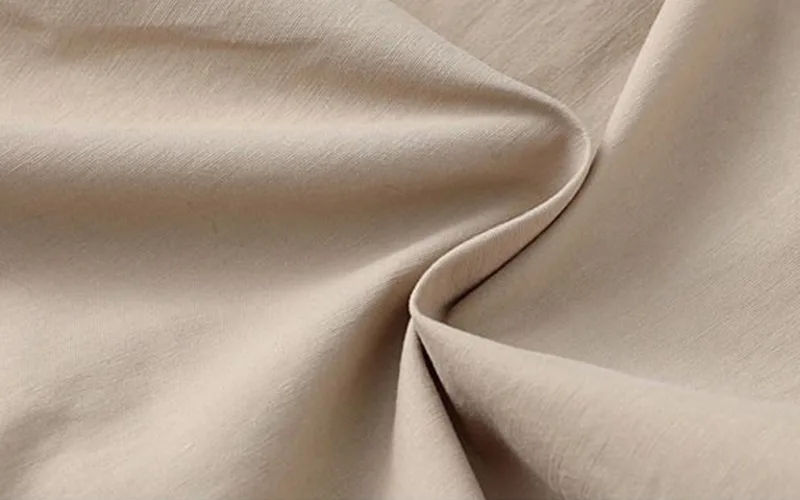 beach short set 4 jpg Beige fabric texture close-up.