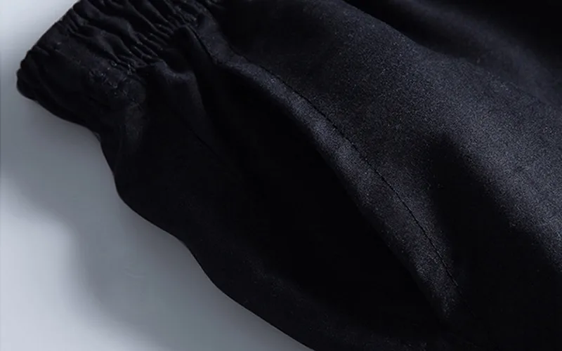 Black elastic waist trousers close-up
