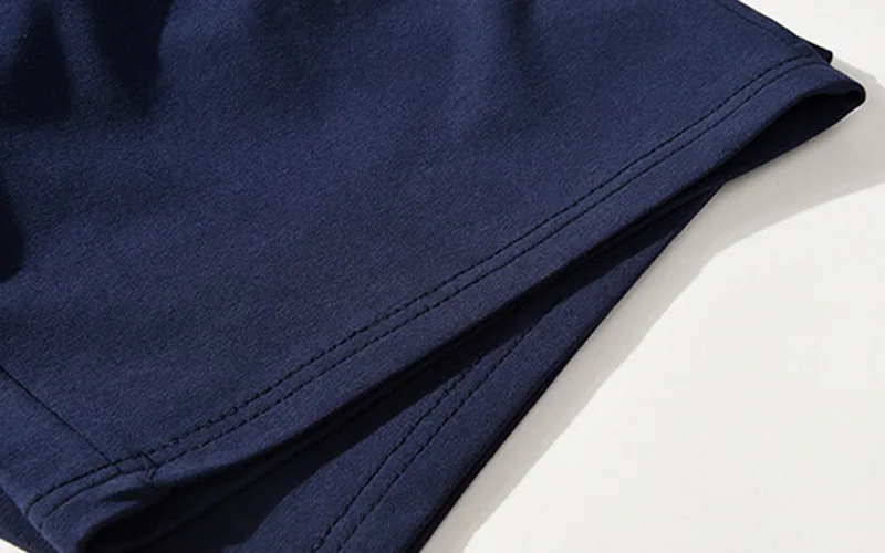 Close-up of navy blue garment fabric detail.