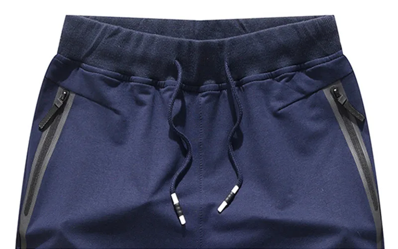 shorts for the beach 7 jpg Blue athletic shorts with drawstring and zip pockets.