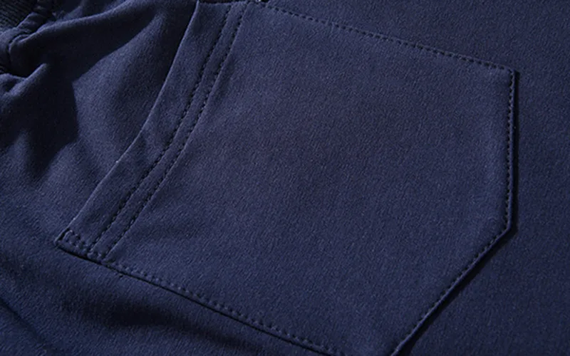 Close-up of navy blue sweatshirt pocket detail.