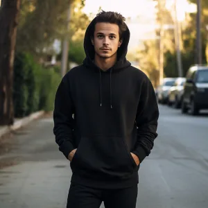 Man in black hoodie on suburban street.