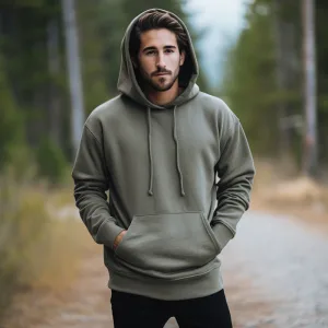 Man in green hoodie standing outdoors.