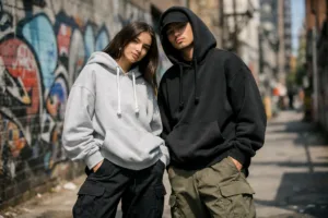 Models in cotton hoodies and cargo pants styled for streetwear in an urban alley setting